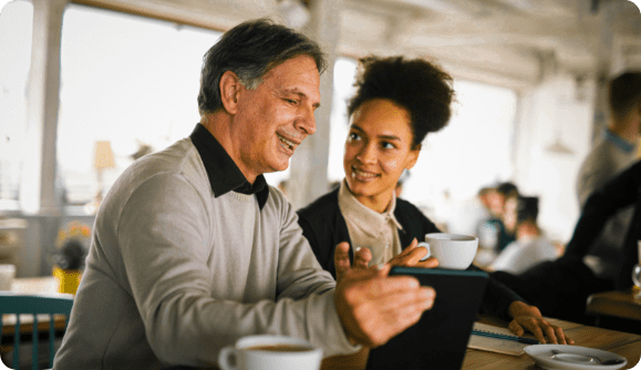 A joyful business Man and one of his employees having a working lunch. A joyful business Man and one of his employees having a working lunch.